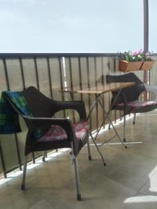 two chairs and a table on a balcony at Lily`s Loft in Yerevan