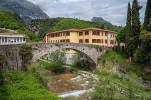an old stone bridge over a river with buildings at Casa Angela -beautiful View lake - Happy Rentals in Toscolano Maderno