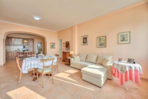a living room with a table and a couch at Casa Angela -beautiful View lake - Happy Rentals in Toscolano Maderno