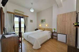 a hotel room with a bed and a television at Dryades & Orion Hotel in Athens