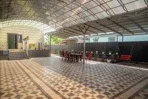 a room with a table and chairs and a ceiling at Гостевой дом Датка in Talas
