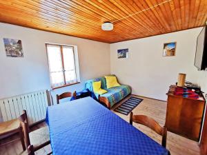a living room with a blue table and a couch at Settimana Cervinia-Valtournenche in Valtournenche