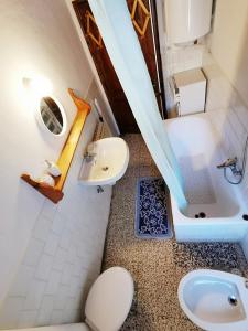 a small bathroom with a sink and a toilet at Settimana Cervinia-Valtournenche in Valtournenche +36 photos
