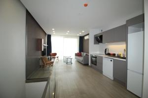 a kitchen and living room with a table and chairs at A'la Grand Residence in Bodrum City