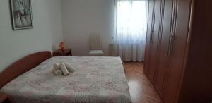 a bedroom with a bed with two white towels on it at Apartman Oliver in Novigrad Istria