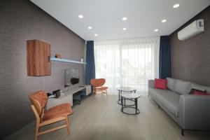 a living room with a couch and a table at A'la Grand Residence in Bodrum City