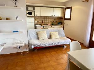 a living room with a couch and a kitchen at Wonderful Apartment with Outstanding Views - Calella de Palfrugell in Calella de Palafrugell