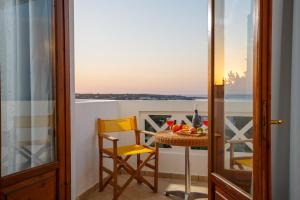 balcón con mesa, sillas y vistas en Romantica Hotel Apartments by Estia en Hersonissos