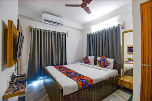 a bedroom with a bed in a room at FabExpress Amar Raj Villa - Nr Eco Park in Kolkata