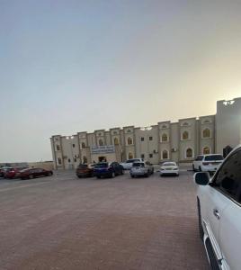 cars parked in a parking lot at Hotel Danat Al Khaleej in Ḩilf