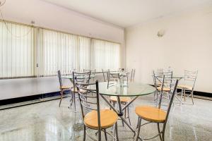 a conference room with a glass table and chairs at FabHotel Emara Grand in Bangalore