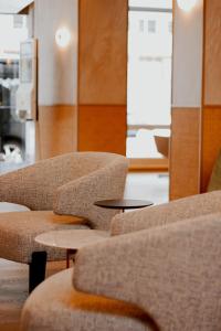 two chairs and a table in a room at The Brunei Hotel in Bandar Seri Begawan