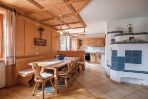 a kitchen with a wooden table and chairs at Mendelhaus in Mendola