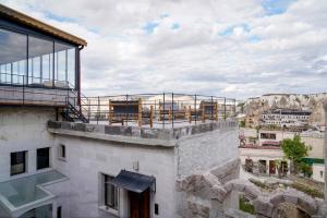 a balcony on top of a building with a view at Concept Cave House in Göreme