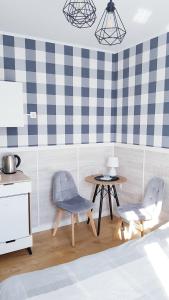 a living room with two chairs and a table at Willa Azur blisko plaży, centrum Mielna in Mielno +16 photos