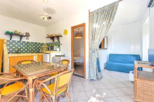 a dining room and living room with a table and chairs at Casa Vacanze Iosè in Rio Marina