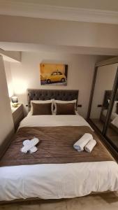 a bedroom with a large bed with two towels on it at Home Boutique Hostel in Baku