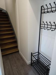 a stairwell with a black metal rail next to a staircase at Appartement Petite Auberge in Saint-Jean-dʼAssé