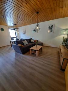 a living room with a couch and a table at Ferienwohnung-Einklang im schönen Südschwarzwald in Todtnau