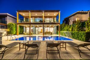 a house with a swimming pool in front of a house at Deluxe Villa Emilie with Private Swimming Pool in Bodrum City