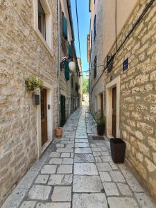 an alley in an old town with buildings at Old Market Residence in Šibenik