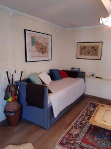 a bedroom with a blue bed with pillows on it at St Elme, maison de pêcheurs, WIFI jardin in Ault