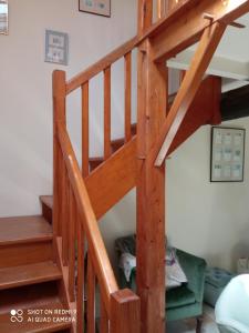 a wooden staircase in a room with a bed at Basse de Ramparts in Vouvant