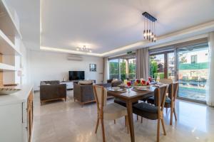 a kitchen and dining room with a table and chairs at Deluxe Villa Emilie with Private Swimming Pool in Bodrum City