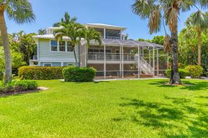 a large house with palm trees in front of it at SEAROSE at The Dunes in Sanibel