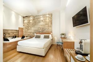 a room with a bed, a table, and a fireplace at Iblaresort Boutique Hotel in Ragusa