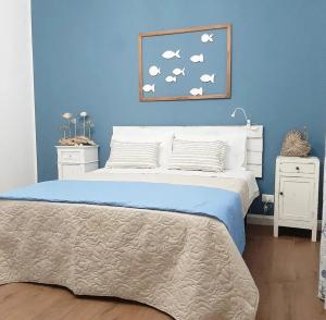 a bedroom with a bed with a blue wall at Stè Sweet home M&A in Scanzano