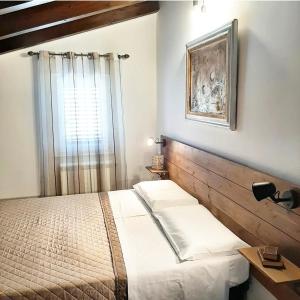 a bedroom with a bed and a window at Stè Sweet home M&A in Scanzano