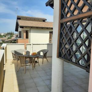 a patio with a table and chairs on a balcony at Stè Sweet home M&A in Scanzano