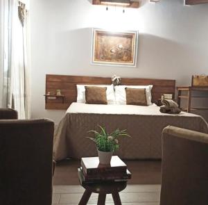 a bedroom with a bed and a table with a plant at Stè Sweet home M&A in Scanzano