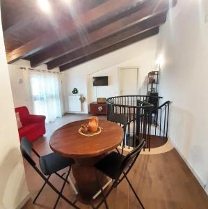 a dining room with a wooden table and chairs at Stè Sweet home M&A in Scanzano