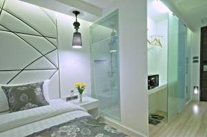 a bedroom with a glass shower and a bed at Sukhumvit Suites Hotel in Bangkok +56 photos