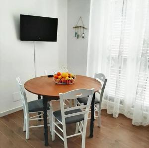 a dining room table with a bowl of fruit on it at Stè Sweet home M&A in Scanzano