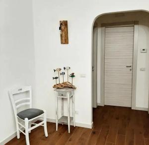 a room with a table and a chair and a door at Stè Sweet home M&A in Scanzano