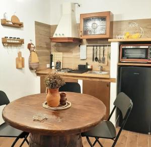 a small kitchen with a wooden table and a kitchen with a sink at Stè Sweet home M&A in Scanzano
