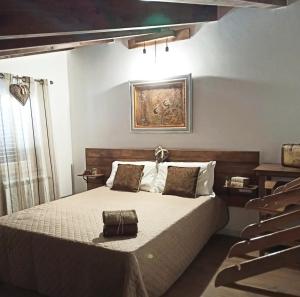 a bedroom with a bed and a painting on the wall at Stè Sweet home M&A in Scanzano