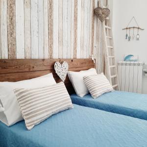 two beds with pillows and a ladder in a bedroom at Stè Sweet home M&A in Scanzano