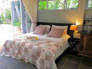 a bedroom with a bed with a book on it at Fiori Rosa in Bloemfontein +37 photos