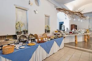 a table topped with lots of plates of food at Meltemi Village Hotel in Perissa