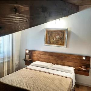 a bedroom with a bed and a painting on the wall at Stè Sweet home M&A in Scanzano