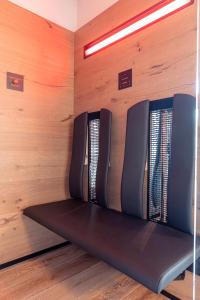 a row of seats in a room with wooden walls at Chalet 149 Westendorf by ALPS RESORTS in Westendorf