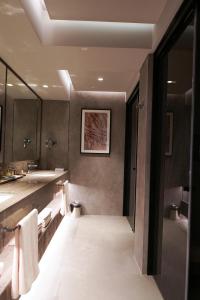 
a bathroom with a sink and a mirror at Rixos Premium Bodrum in Torba
