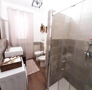 a bathroom with a shower and a sink and a toilet at Stè Sweet home M&A in Scanzano