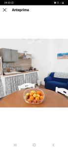 a bowl of oranges sitting on a table in a kitchen at Stè Sweet home M&A in Scanzano