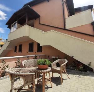 a patio with chairs and a table with a potted plant at Stè Sweet home M&A in Scanzano