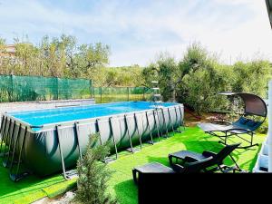 a swimming pool in the backyard of a house at La Casetta tra Sassi e Ulivi B&B in Matera